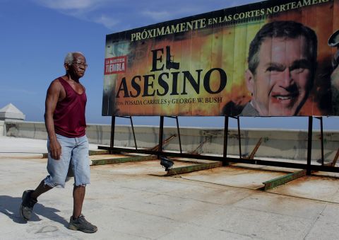 A 2006 billboard in Havana reads "Coming Soon to North American Courts: 'The Assassin' with Posada Carriles and George W. Bush."