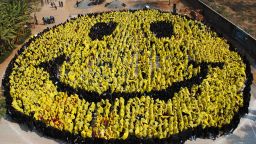 4444 students from 25 schools in Gwalior stand together and form a smiley face by holding coloured cloths in Gwalior on February 8, 2012 in an attempt to break the Guiness Book World Record of the largest human smiley face. AFP PHOTO/STR (Photo credit should read STRDEL/AFP/Getty Images)