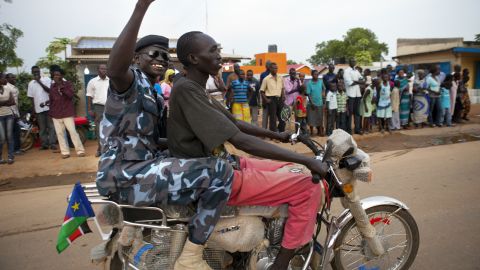 A South Sudanese policeman cheers on July 8 as people celebrate the eve of the country's independence day in Juba. 
