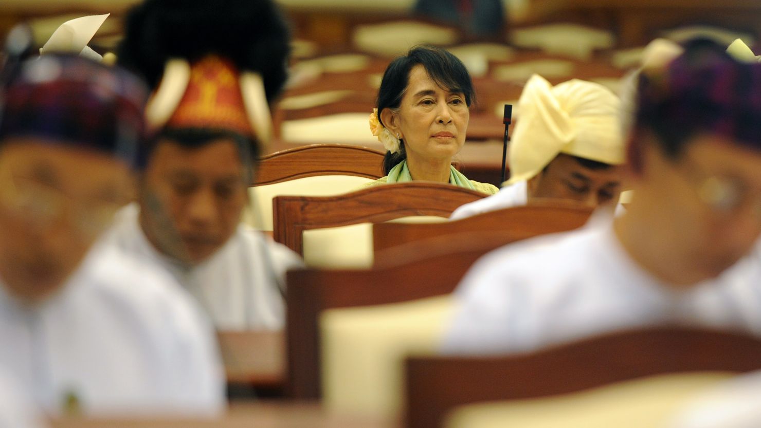 Aung San Suu Kyi sits in Myanmar's parliament this summer. Many say she cannot bring progress to her country by herself.