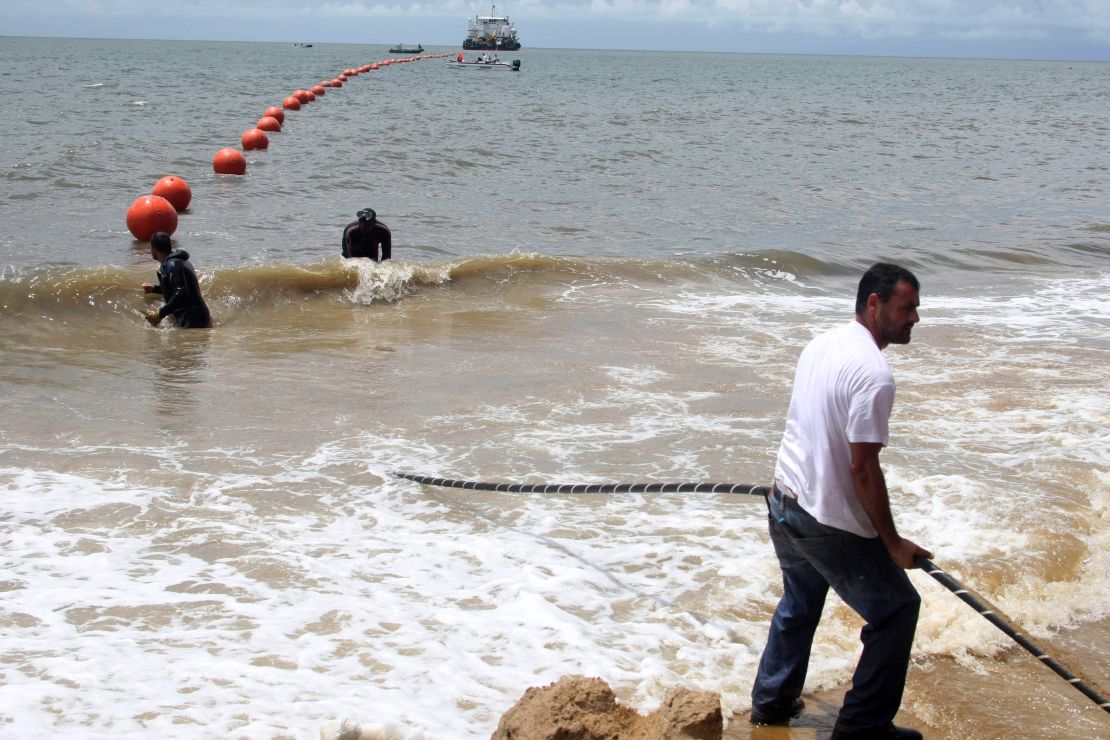 Technicians lay a fiber optic cable in October 2011 to allow Gabon and 22 African countries to get an Internet connection.