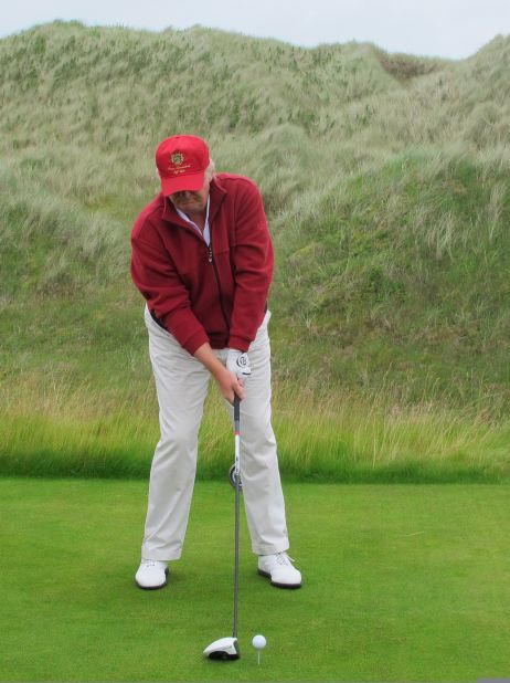 Trump, who has delayed plans to build an extended $1 billion resort on the east coast of Scotland, hits the course's first ever shot.