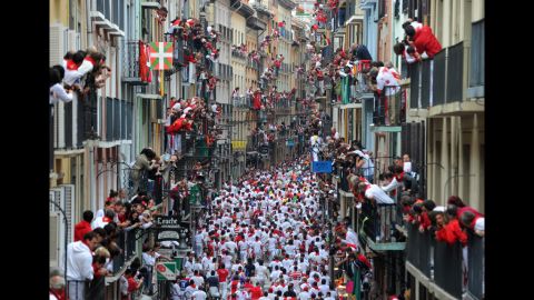 Thousands fill the streets and balconies along Estafeta Street during the San Fermin festivities Monday.