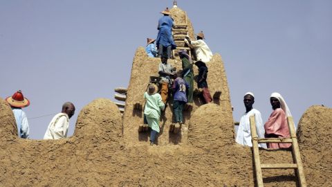 On April 10, 2006, residents restore the City of 333 Saints' Great Djingareyber Mosque in Timbuktu. The Islamists controling northern Mali destroyed two tombs there Tuesday., witnesses said.