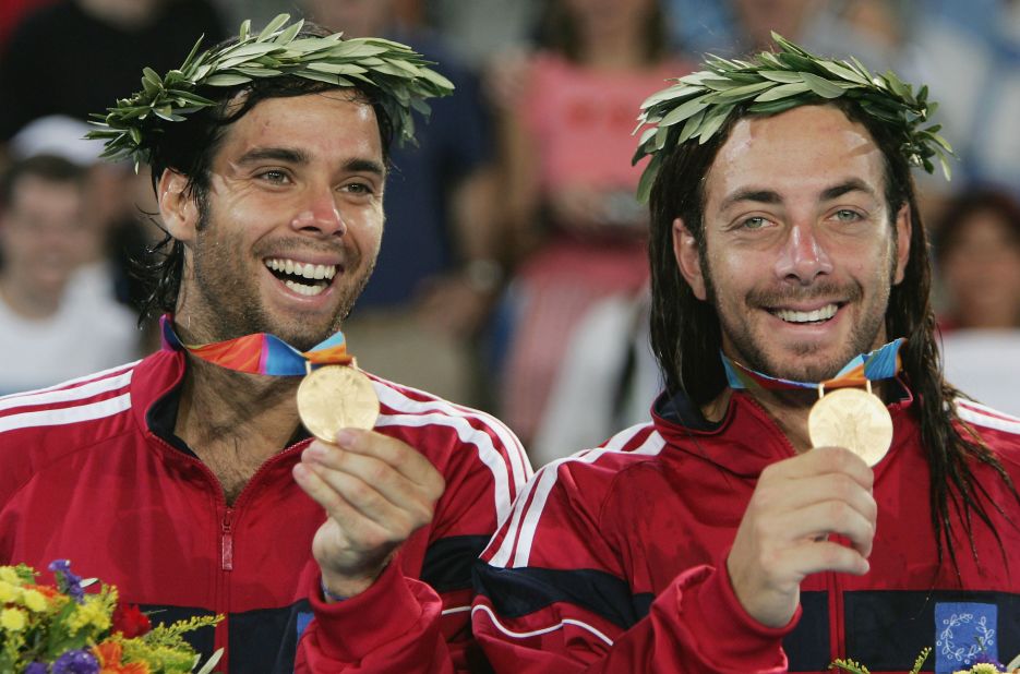 Gonzalez and partner Nicolas Massu proudly show the gold medals they won in the men's doubles at the 2004 Olympics in Athens.