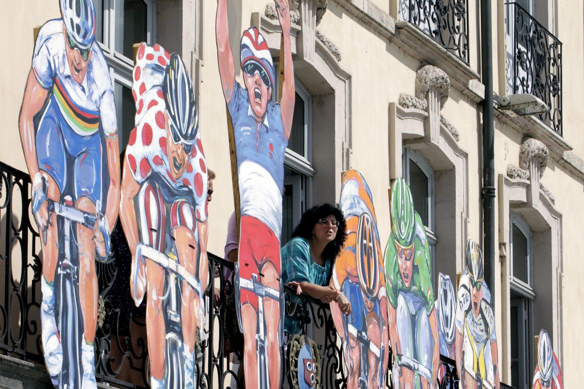Large cutouts of cyclists in colorful jerseys are featured on the facade of a building in Macon on Wednesday.