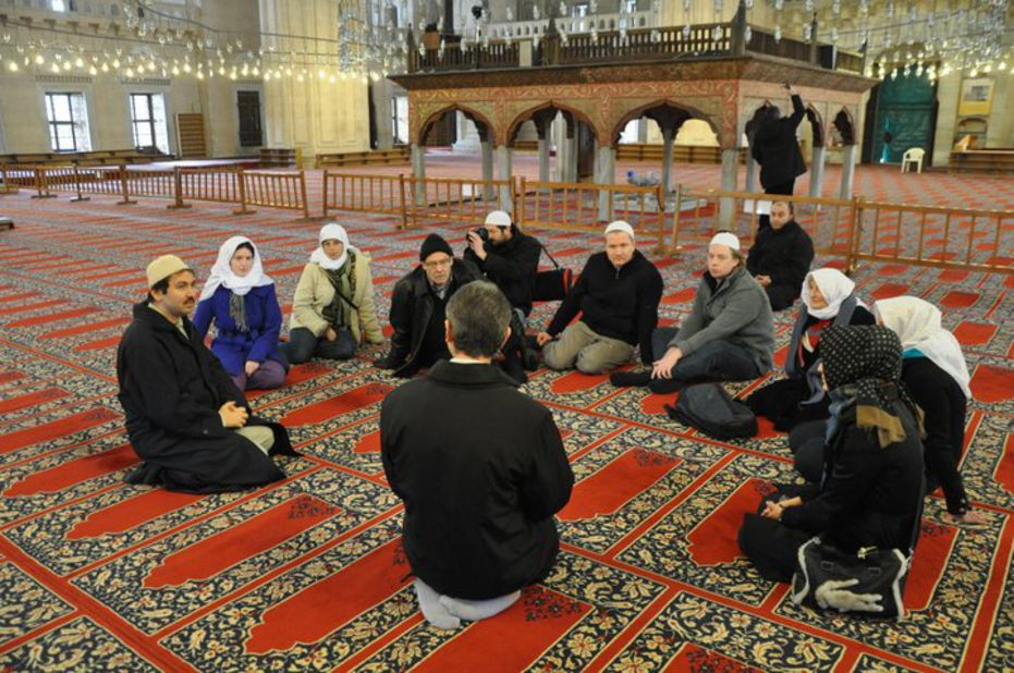 The tour group inside Istanbul's Blue Mosque, being taught Islamic practices.