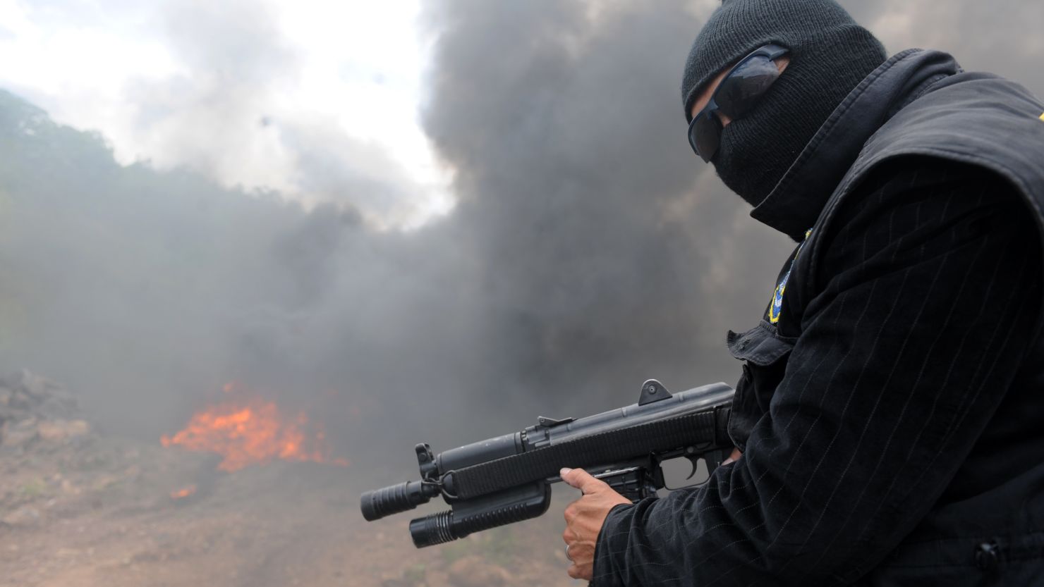 A policeman stands watch during the incineration of 456 kilos of cocaine on July 4 near Tegucigalpa, Honduras. 