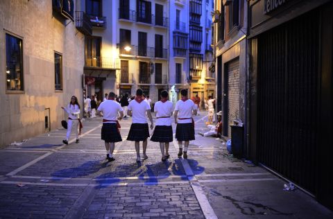 Scottish runners from Glasgow and Aberdeen wearing kilts walk through the streets of Pamplona before the sixth day of festivities Thursday morning.