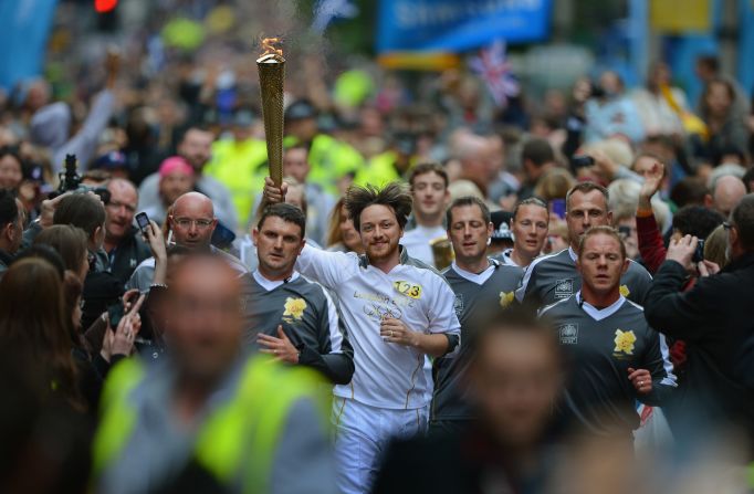 Actor James McAvoy carries the torch down Buchanan Street in Glasgow, Scotland, on June 8.