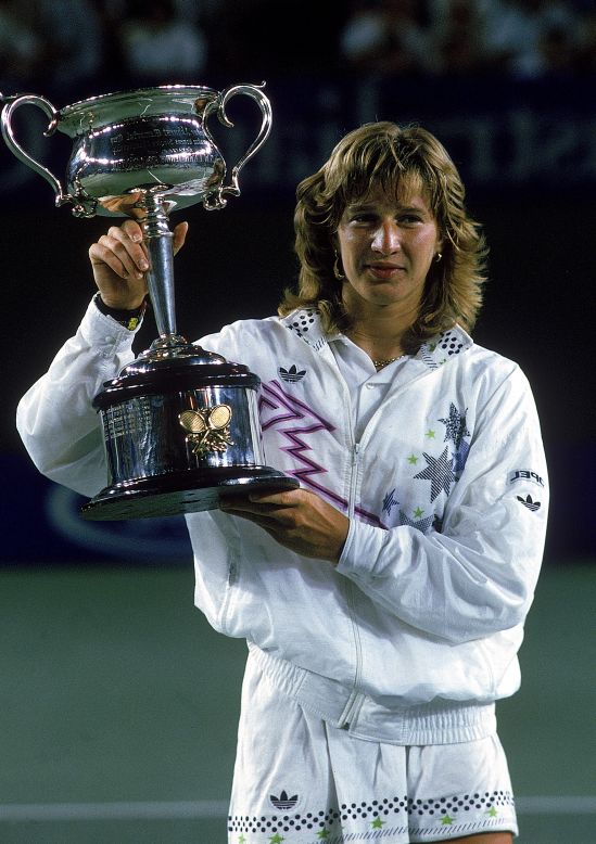 Graf holds aloft the 1988 Australian Open title, the first leg of her "Golden Slam" that year.