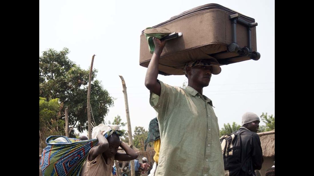 Refugees escape to a refugee camp in Kiwanja on July 8, a trek made more dangerous by the looting of the Congolese army.