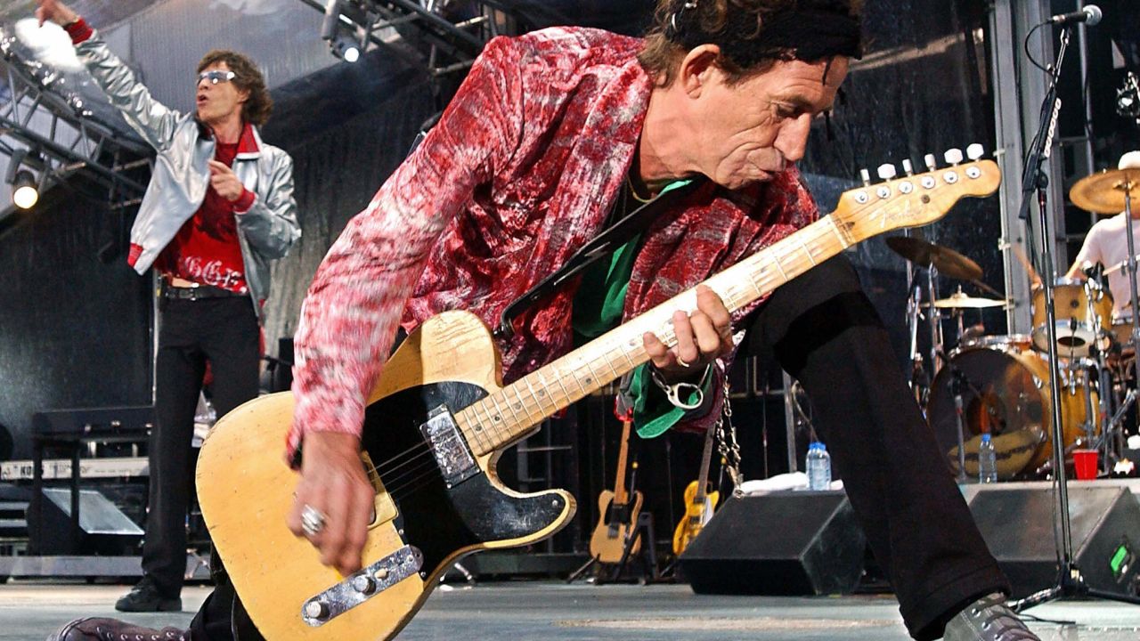 Rolling Stones guitarist Keith Richards (R) rocks the house, as singer Mick Jagger (L) belts out a favorite during their concert in Munich, June 6, 2003.