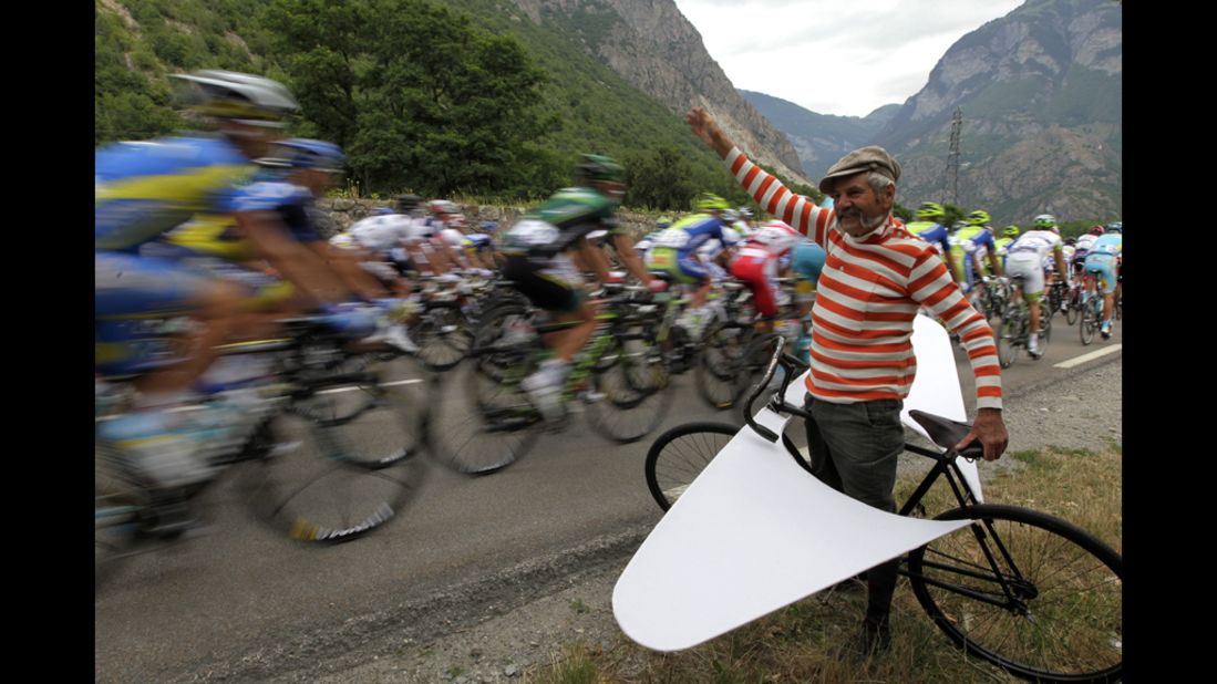 A fan cheers on the pack riding in the 226-km (140-mile) stage 12 of the 2012 Tour de France, starting in Saint-Jean-de-Maurienne and finishing in Annonay Davezieux, southeastern France, on Friday, July 13. 