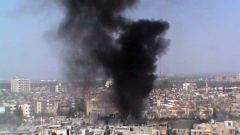 A picture released by the Syrian opposition shows smoke rising from a Homs neighborhood on Wednesday.