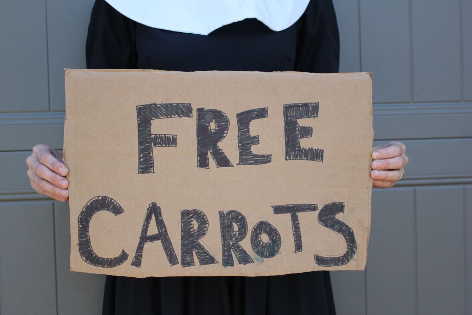 Mavis refused to let her overabundance of carrots go to waste, so she dressed up in a pilgrim outfit and handed them out for free.