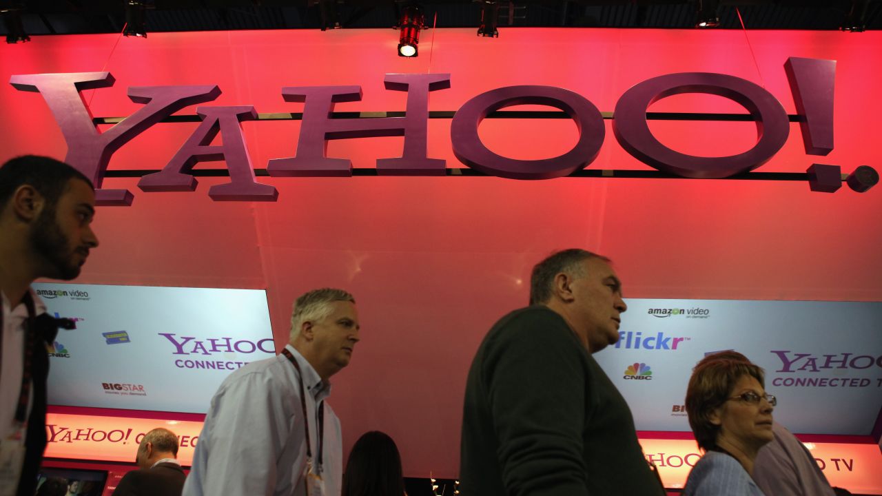 Visitors walk past the Yahoo booth at the Consumer Electronics Show in Las Vegas.
