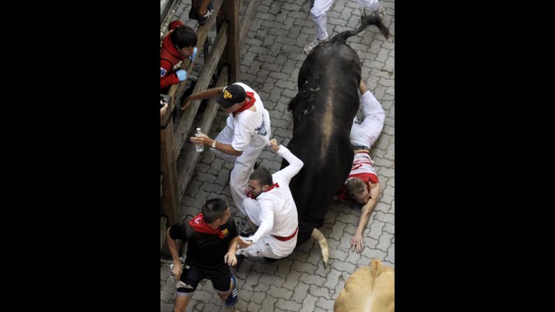 Participants run in front of Don Juan Pedro Domecq's bulls, during the seventh bull run of the San Fermin festival, in the the Northern Spanish city of Pamplona, on Friday, July 13. 