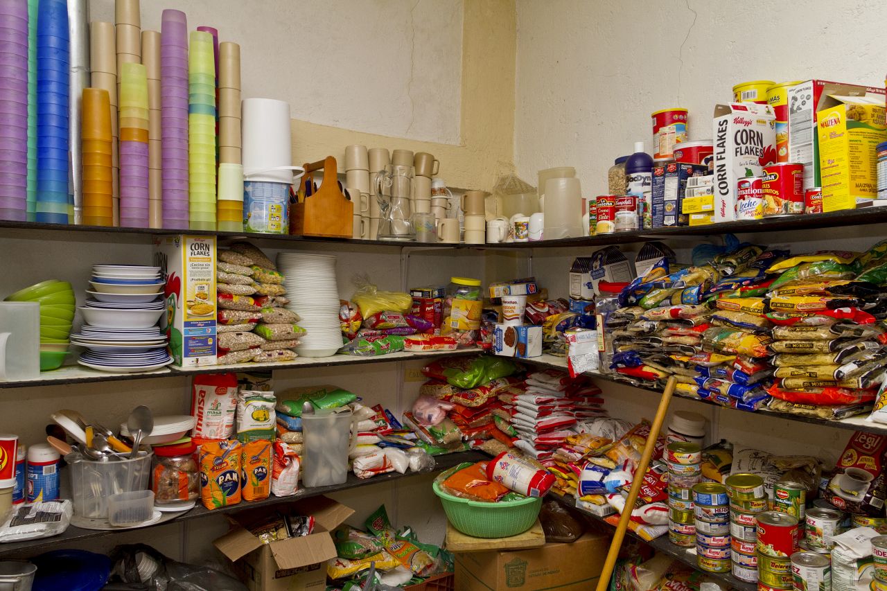 With a well-stocked pantry, cooks prepare warm meals for dozens of Central American immigrants daily. 