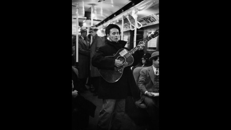 Woody Guthrie entertains New York commuters in 1943, strumming a guitar bearing his now-famous slogan, "This Machine Kills Fascists."
