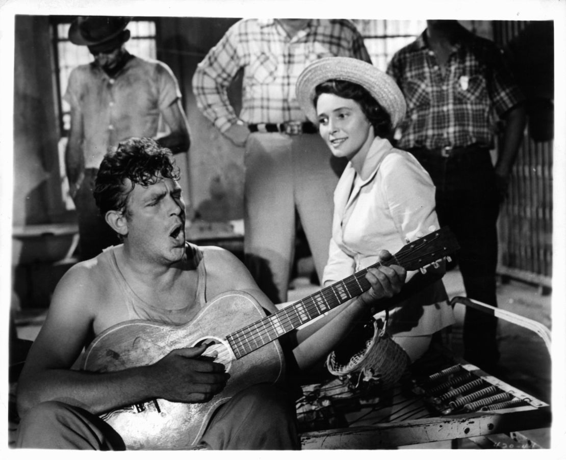 Andy Griffith plays guitar as Patricia Neal watches in a scene from the 1957 film "A Face In The Crowd."