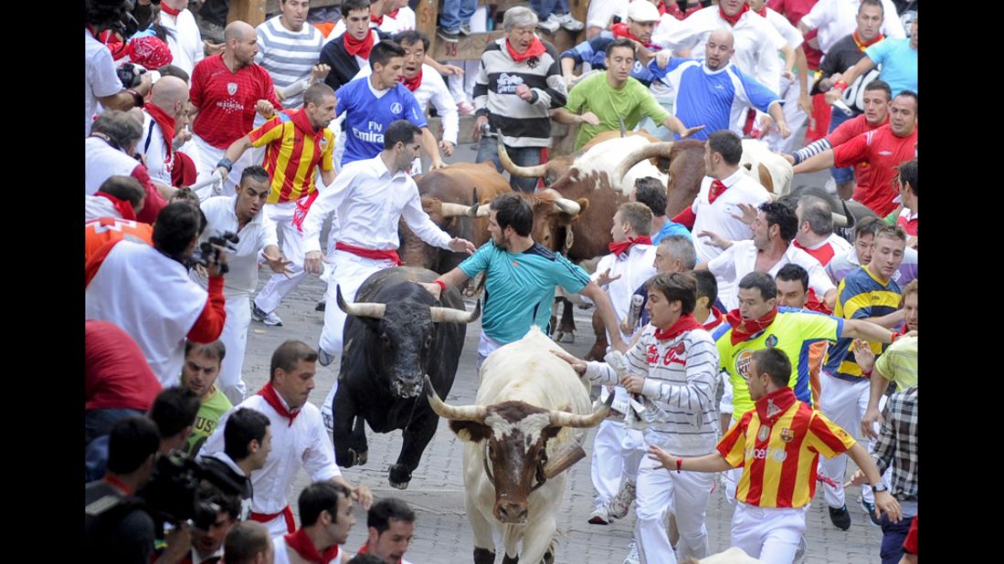Participants run during the last day of the Running of the Bulls on Saturday, July 14, in Pamplona, Spain. The dangerous tradition has tallied thousands of injuries and 15 deaths since record-keeping began in 1924, including the fatal goring of a Spanish man in 2009.