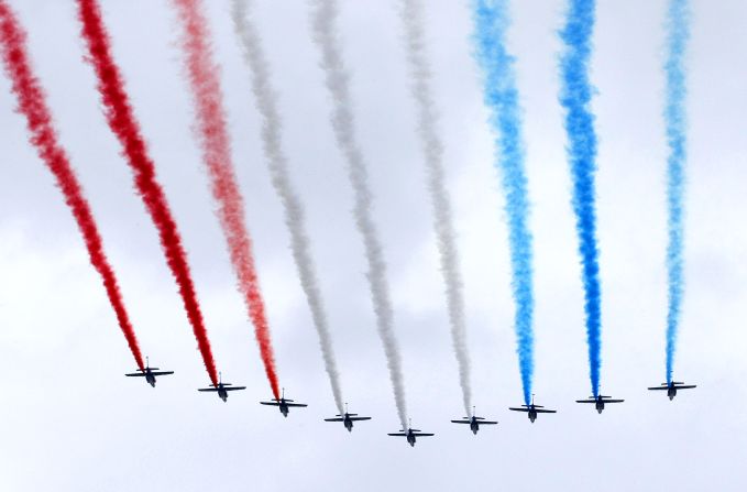 The Patrouille de France military planes fly over the Champs Elysee avenue in Paris to open the Bastille Day military parade.