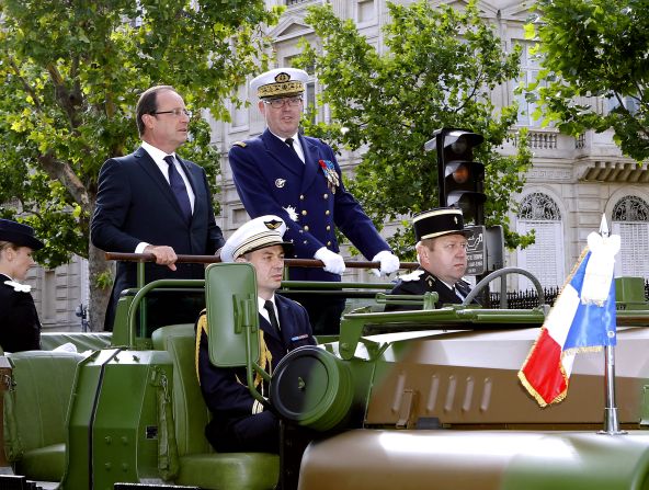 France's President Francois Hollande (left) and French Army Chief of Staff Admiral Edouard Guillaud review the troops. 