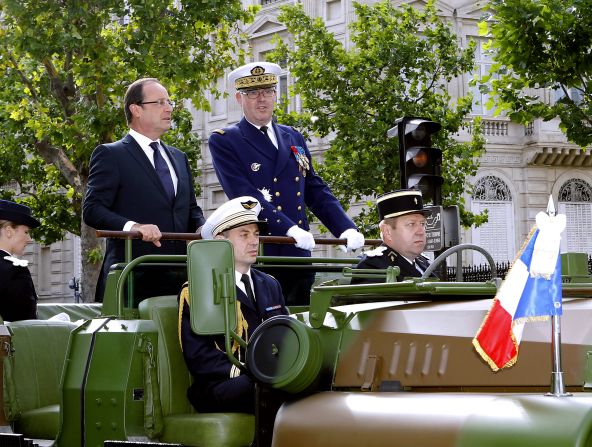 France's President Francois Hollande (left) and French Army Chief of Staff Admiral Edouard Guillaud review the troops.