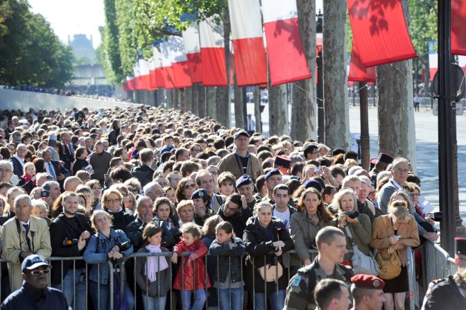 Crowds line the Champs Elysees to watch the Bastille Day parade.