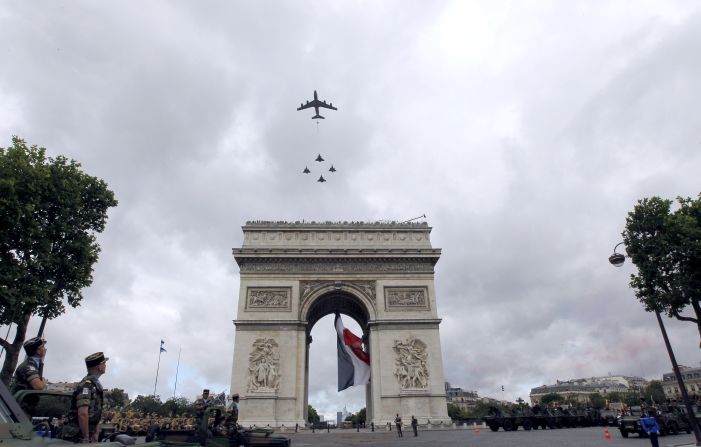 French military aircraft fly over the Arc de Triomphe in Paris to celebrate Bastille Day.