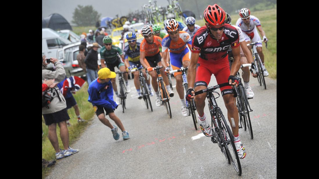 Philippe Gilbert of Belgium and Team BMC leads a breakaway group as rain starts to fall Sunday.