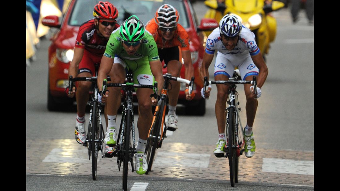 Slovakia's Peter Sagan, wearing the green jersey of the sprint points leader, reaches for second place at the finish of the race Sunday and maintains his lead as sprints points leader, 97 points ahead of Andre Greipel of Germany.