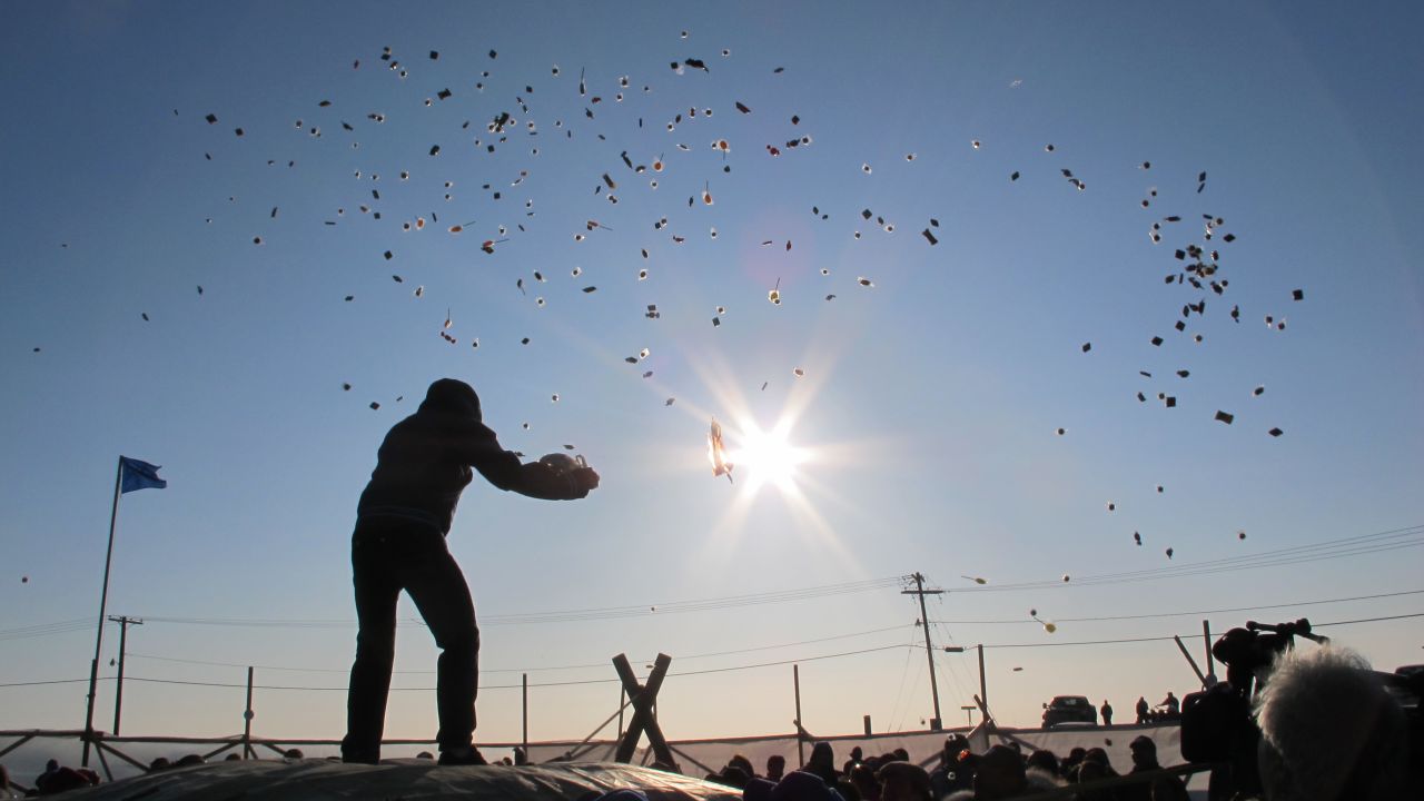Barrow, Alaska, residents enjoy a traditional blanket toss. The community is wrestling with the idea of proposed off-shore oil rigs.