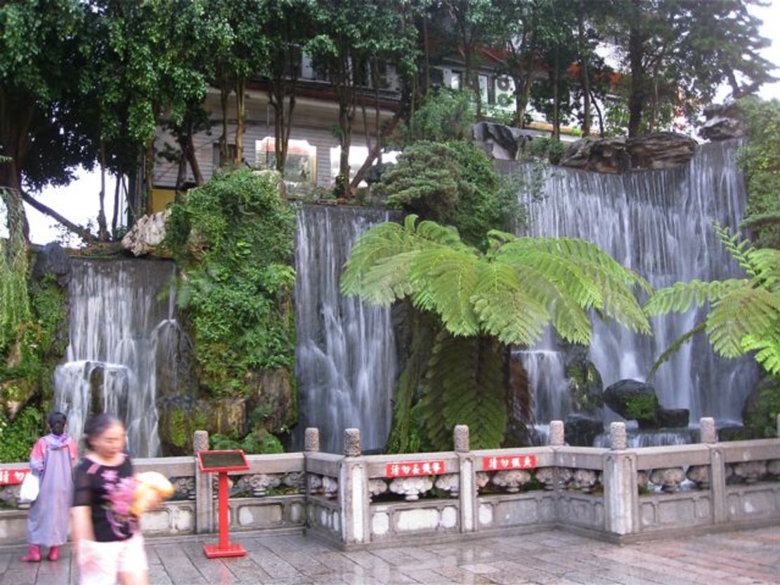 A waterfall welcomes visitors inside the first gate