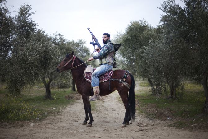 A Free Syrian Army rebel mounts his horse in the Al-Shatouria village near the Turkish border in northwestern Syria on March 16, 2012, a year after the uprising began.