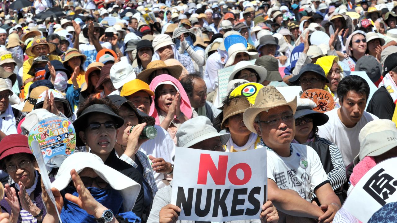 People hold placards to protest against nuclear power plants in Tokyo on July 16, 2012. 