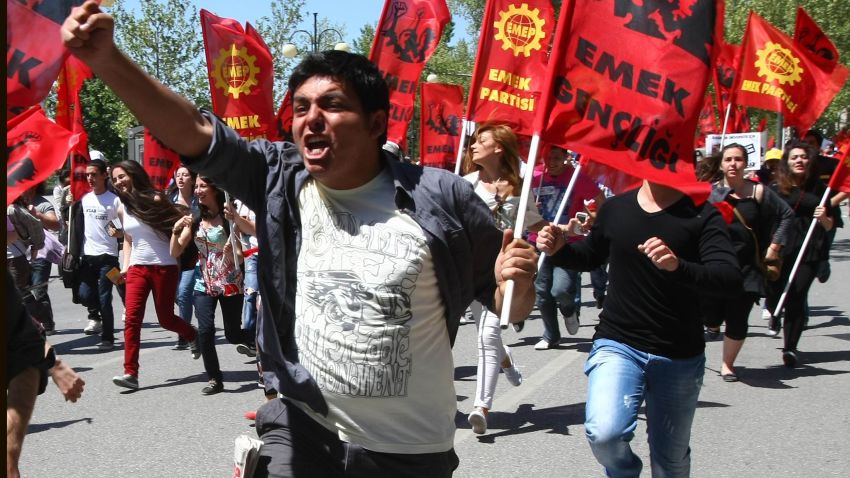 Activists run during May Day protests in Ankara on May 1, 2012. Fed up with high unemployment and austerity, May Day protesters took to the streets across Europe today in a wave of anger that threatens to topple leaders in Paris and Athens. AFP PHOTO/ADEM ALTAN (Photo credit should read ADEM ALTAN/AFP/GettyImages) 