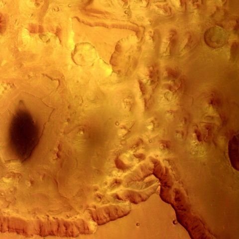 The European Space Agency's Mars Express captured this view of Valles Marineris in 2004. The area shows mesas and cliffs as well as features that indicate erosion from flowing water.