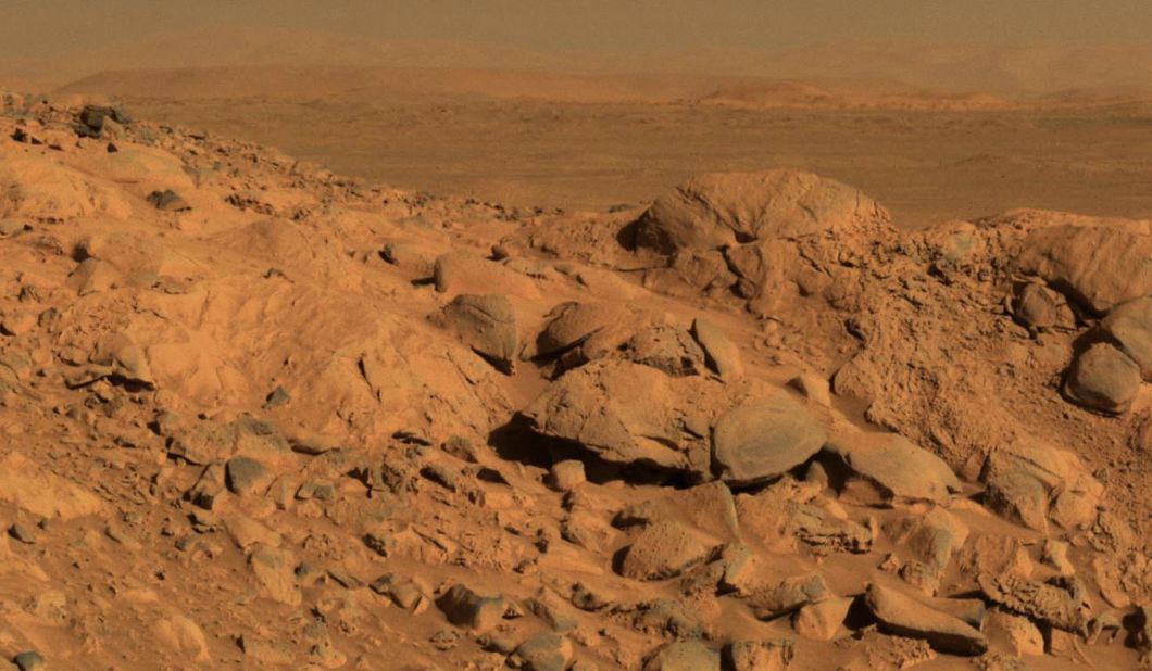 A rock outcrop dubbed Longhorn and the sweeping plains of the Gusev Crater are seen in a 2004 image taken by the Mars Exploration Rover Spirit.