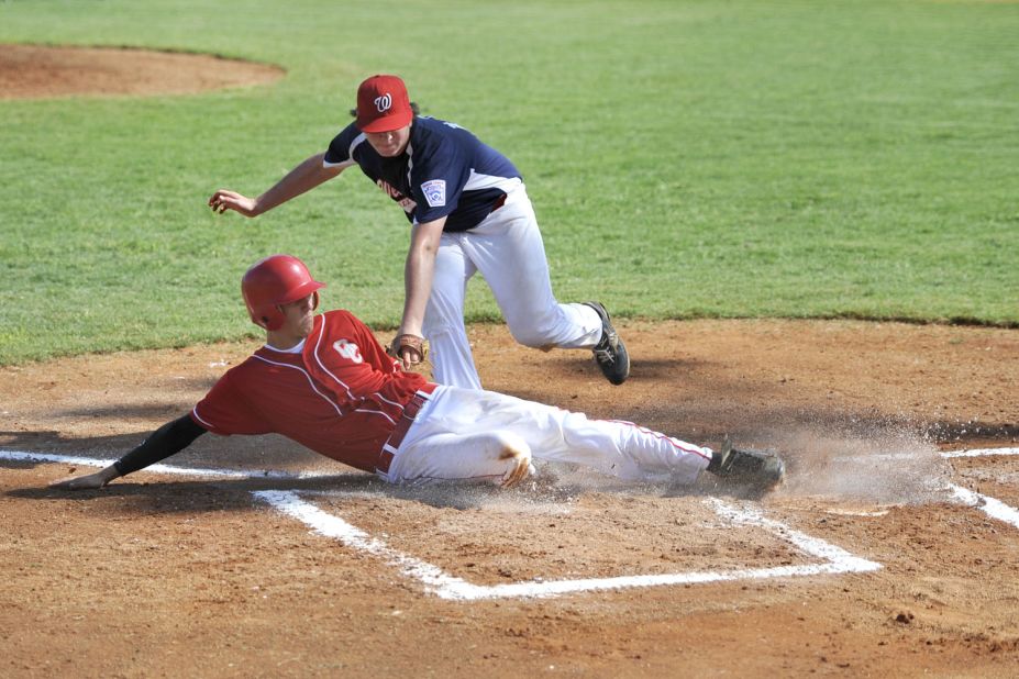When shooting sports like baseball, be prepared for action to occur in certain areas, such as home plate, and pre-set your focus and exposure. 