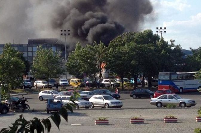 Smoke rises over Bulgaria's Burgas Airport after an explosion on a bus carrying Israeli tourists on Wednesday, July 18. At least six are dead.