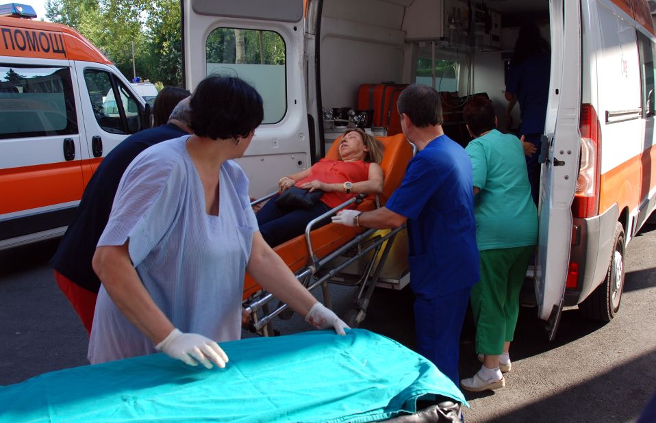 Bulgarian medics unload a wounded woman from an ambulance at a hospital.