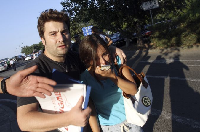 Bystanders react to the explosion. Key Israeli politicians have pointed to Iran as the likely instigator.