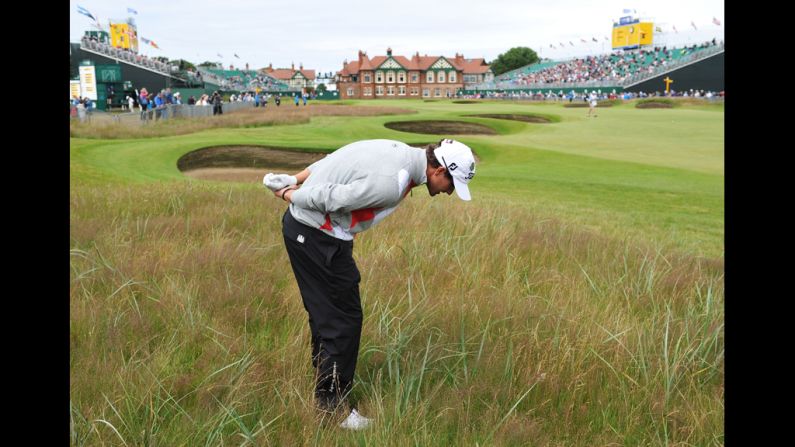Scott looks at the lie of his ball in the deep rough on the 18th hole Thursday.