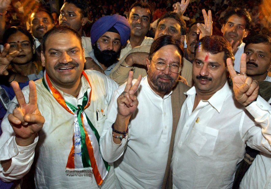 Khanna, center, who was elected to the lower house of the Indian parliament in 1992, shows a victory sign during a Congress Party election campaign meeting in New Delhi in November 2003.