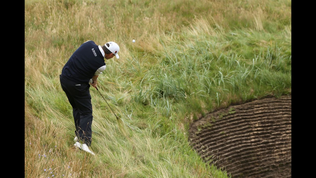 Scottish golfer Paul Lawrie plays a shot from the rough on the eighth hole Thursday.