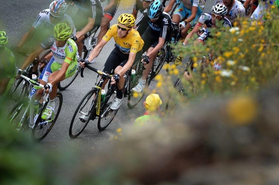 Overall race leader Bradley Wiggins of Great Britain, in yellow, rides in the main group during Thursday's race.