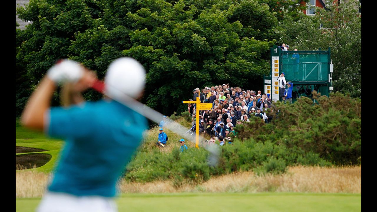 Spectators watch the action as Sergio Garcia of Spain hits a tee shot during the first round Thursday.