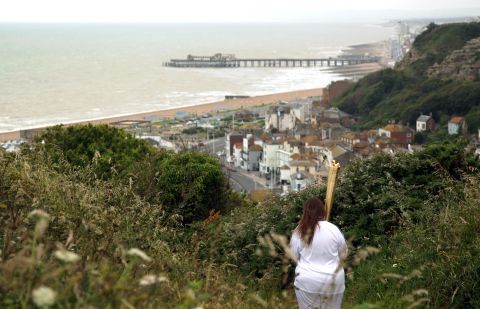 Torchbearer Daisy Shepherd of East Sussex carries the Olympic flame through Hastings on the southern coast of England on Wednesday, July 18. 